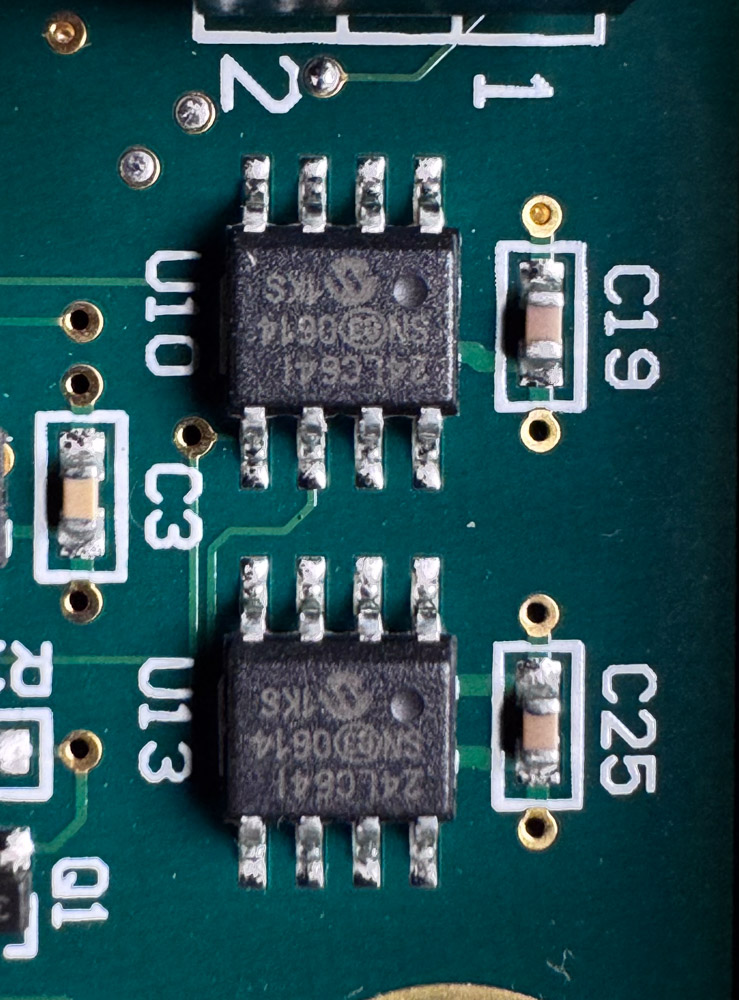 The 24LC64 EEPROMs at U10 and U13